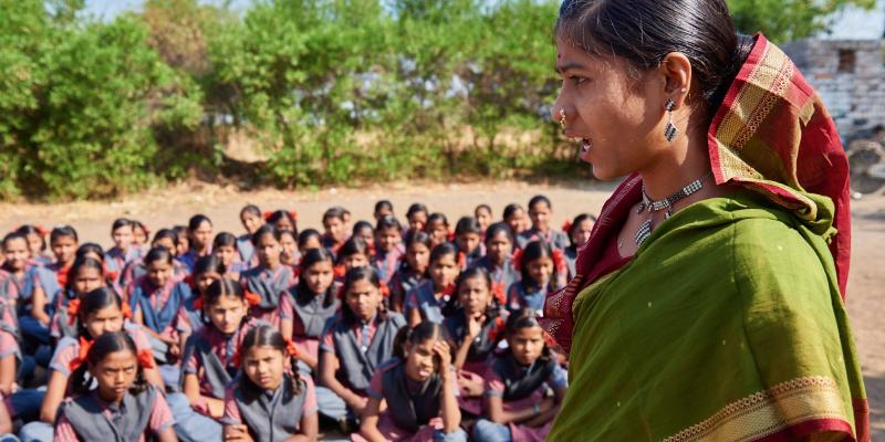 a woman with a group of girls