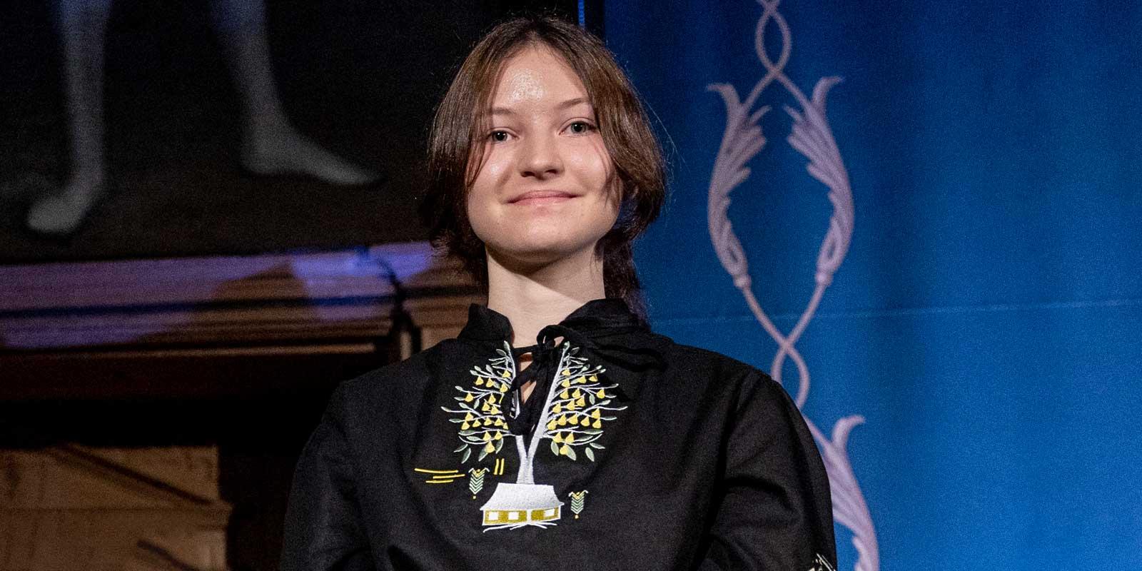 A young girl in a Ukrainian blouse. 