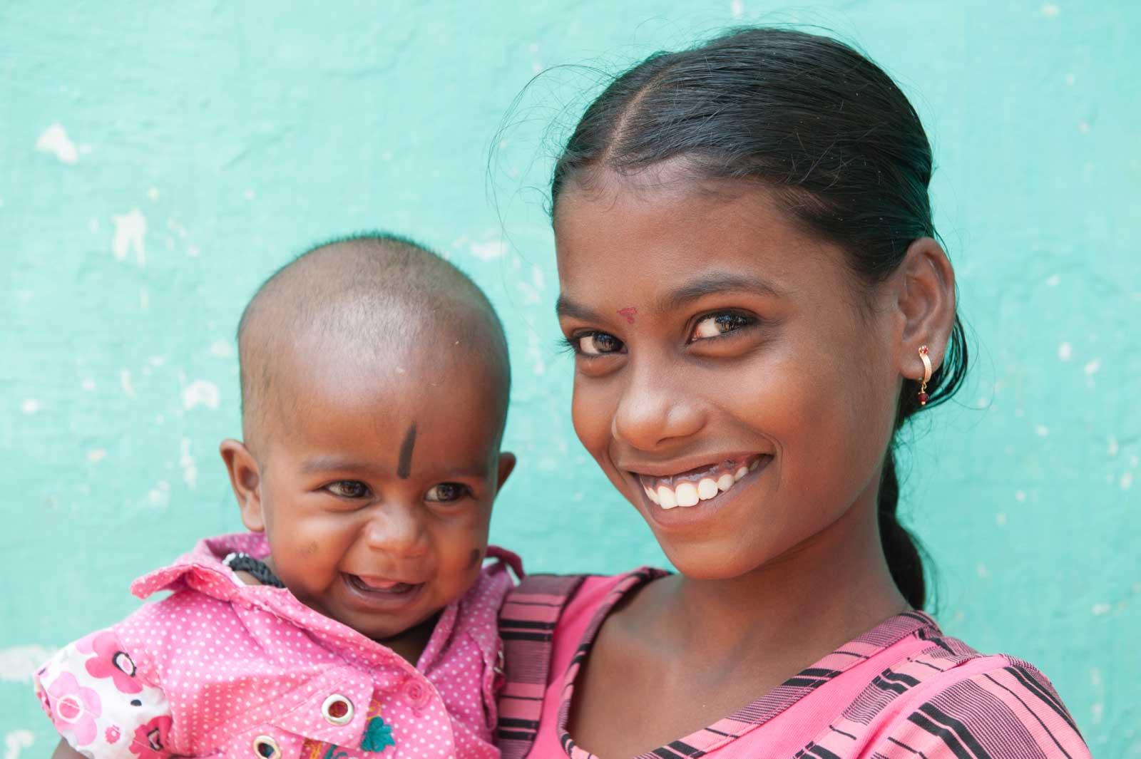 Annandhi holds a baby girl.