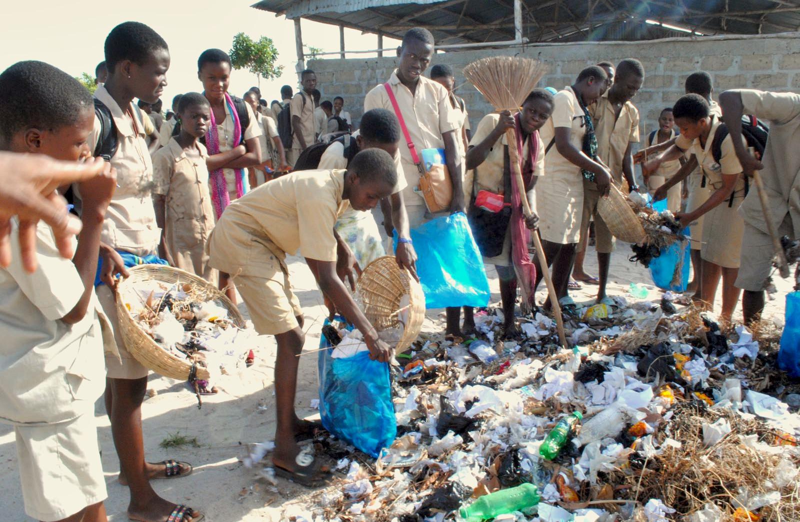 People gathered around a pile of litter, cleaning up