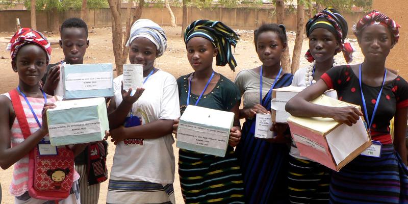 Kids holding ballot boxes
