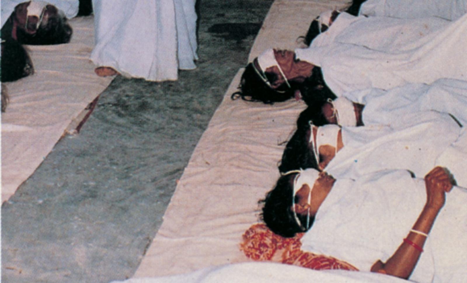 Blind children in Bangladesh, who have just received eye operations, are resting on the floor. 