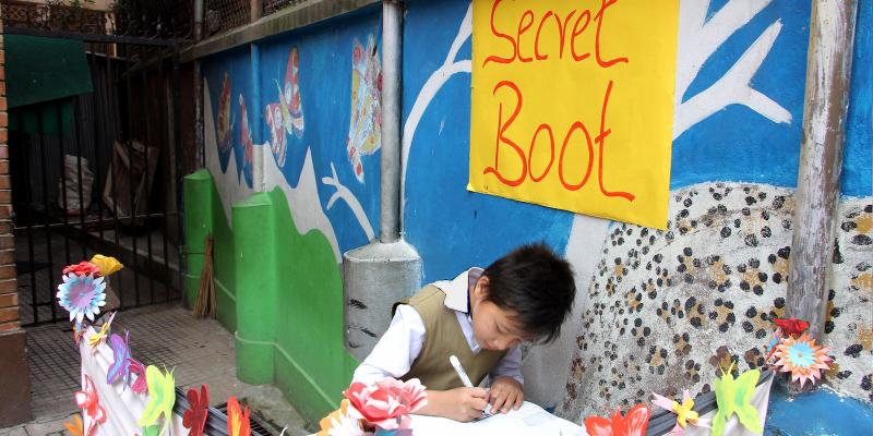 Young boy in Nepal in a colorful voting booth. 