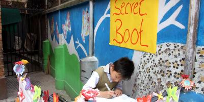Young boy in Nepal in a colorful voting booth. 