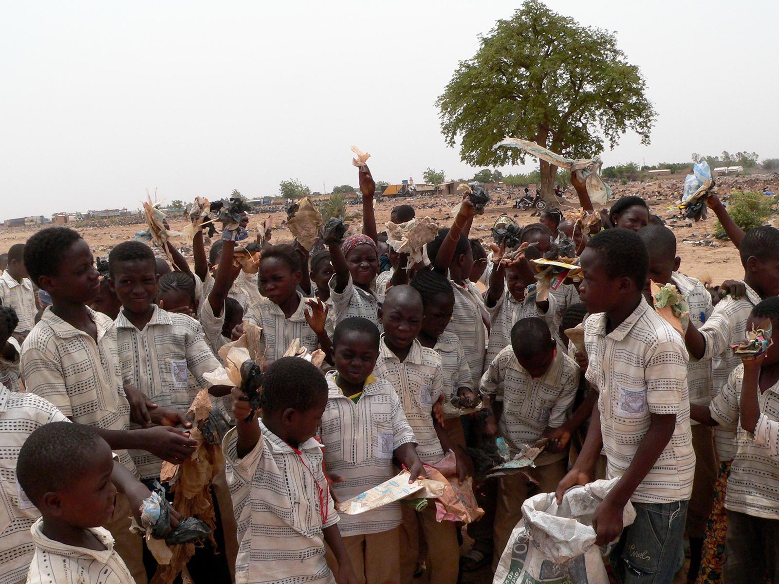 Children holding litter in the air