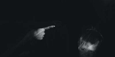 Hand admonishing crying child