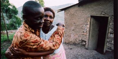 Bwami and his mum outside their house