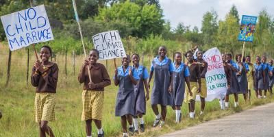 Children in line holding signs