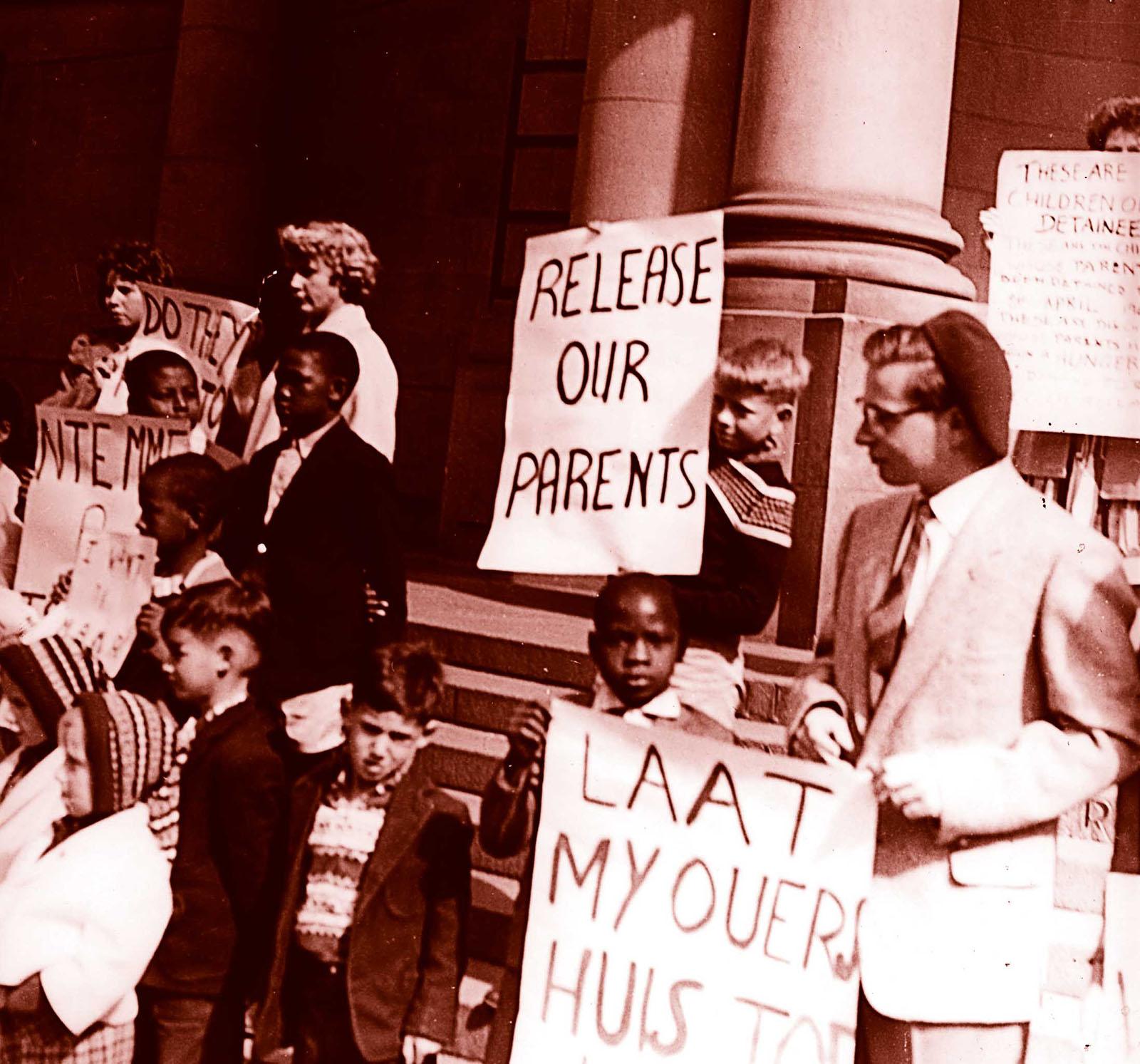 children protesting  that their parents are put in prison