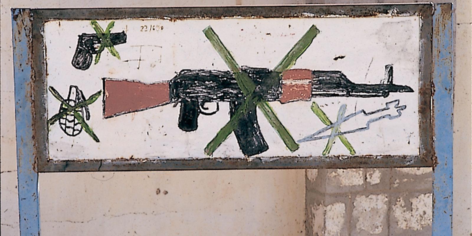 Child's drawing of crossed-over gun and hand grenades.