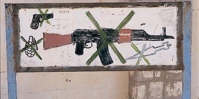 Child's drawing of crossed-over gun and hand grenades.