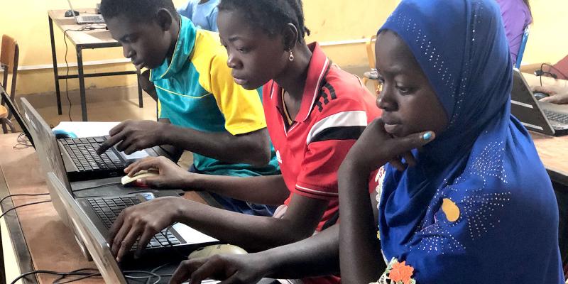 Teenagers in front of computers.