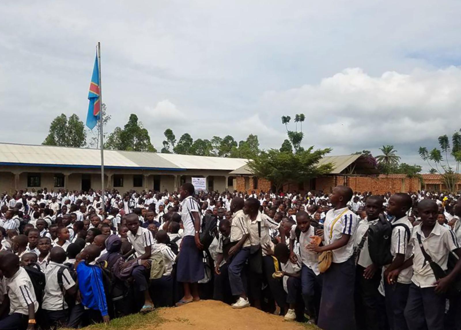 Many children gathered outside a school 