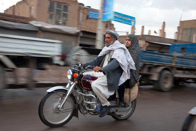 Father and daughter on motorbike.