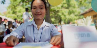 Girl checking voting register on Global Vote Day