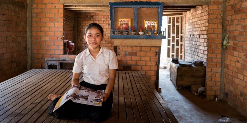 Girl sitting with Globe in her lap