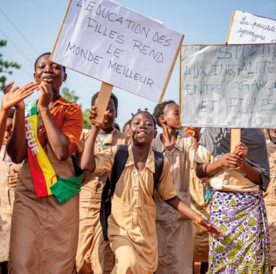 Girls showing signs about children's and girls' rights. 