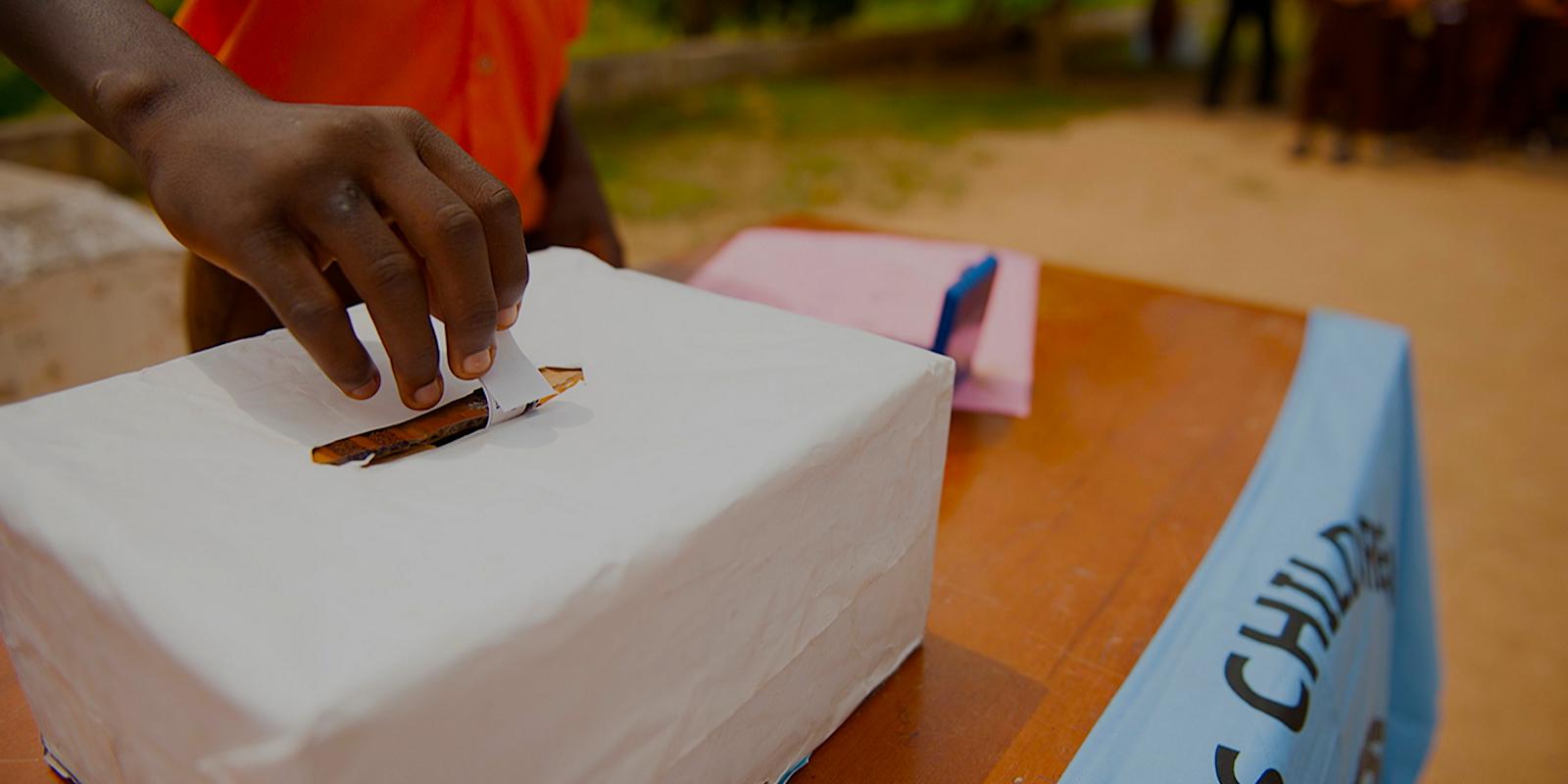 Hand casting ballot in box