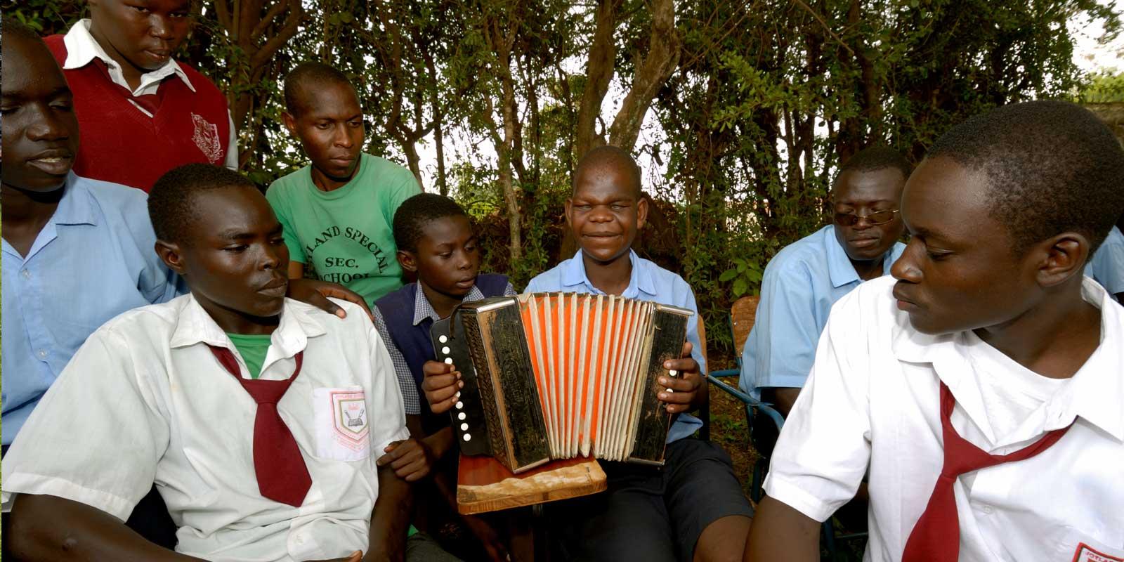 a group of children, one with an accordion