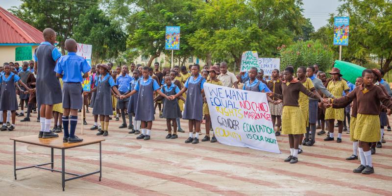 Kim and Hassan stand on a table, opening the run.
