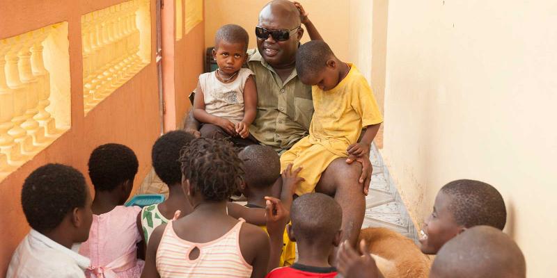 Manuel talks with a group of children