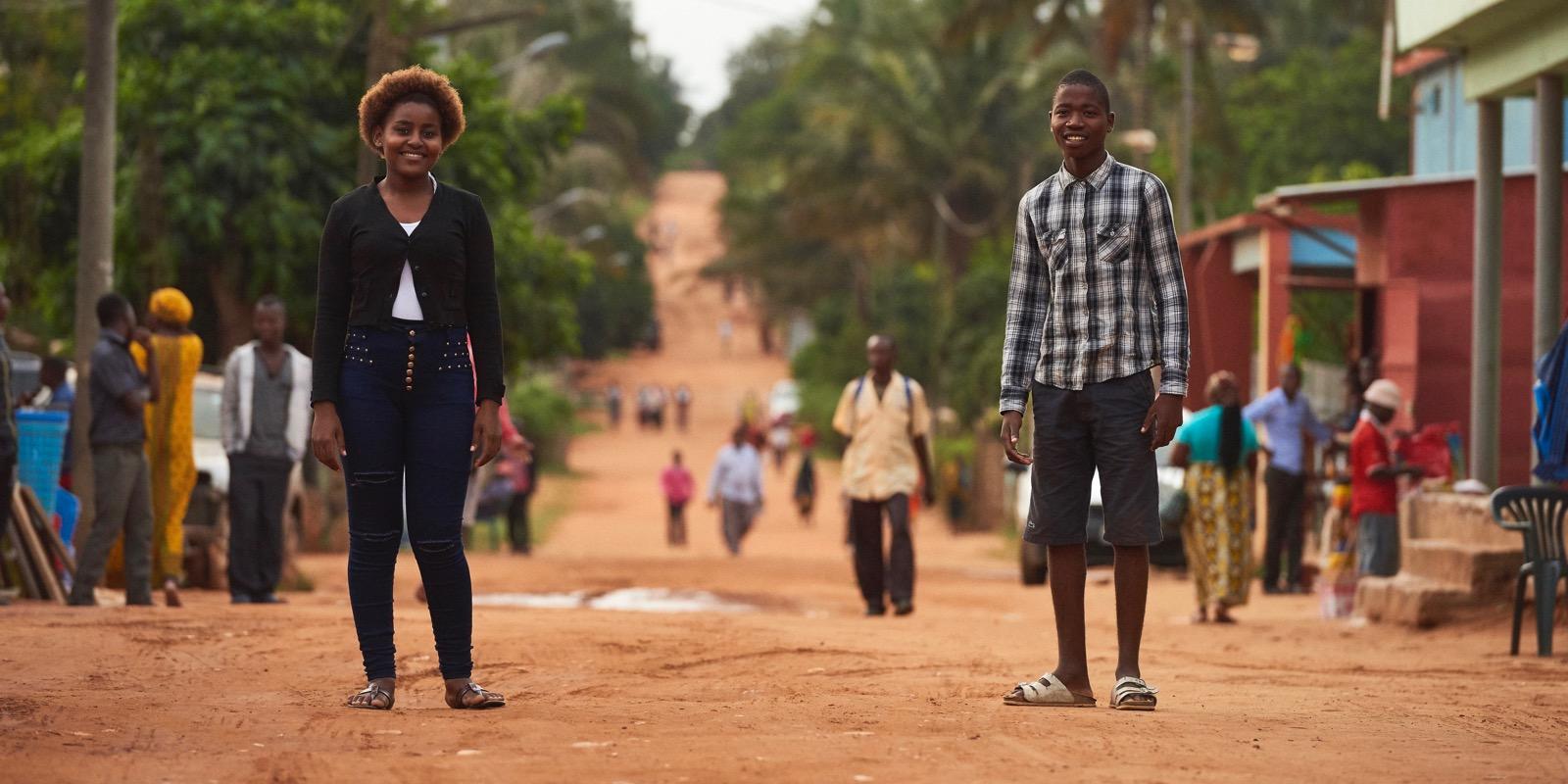 Girl and boy standing in dirt road