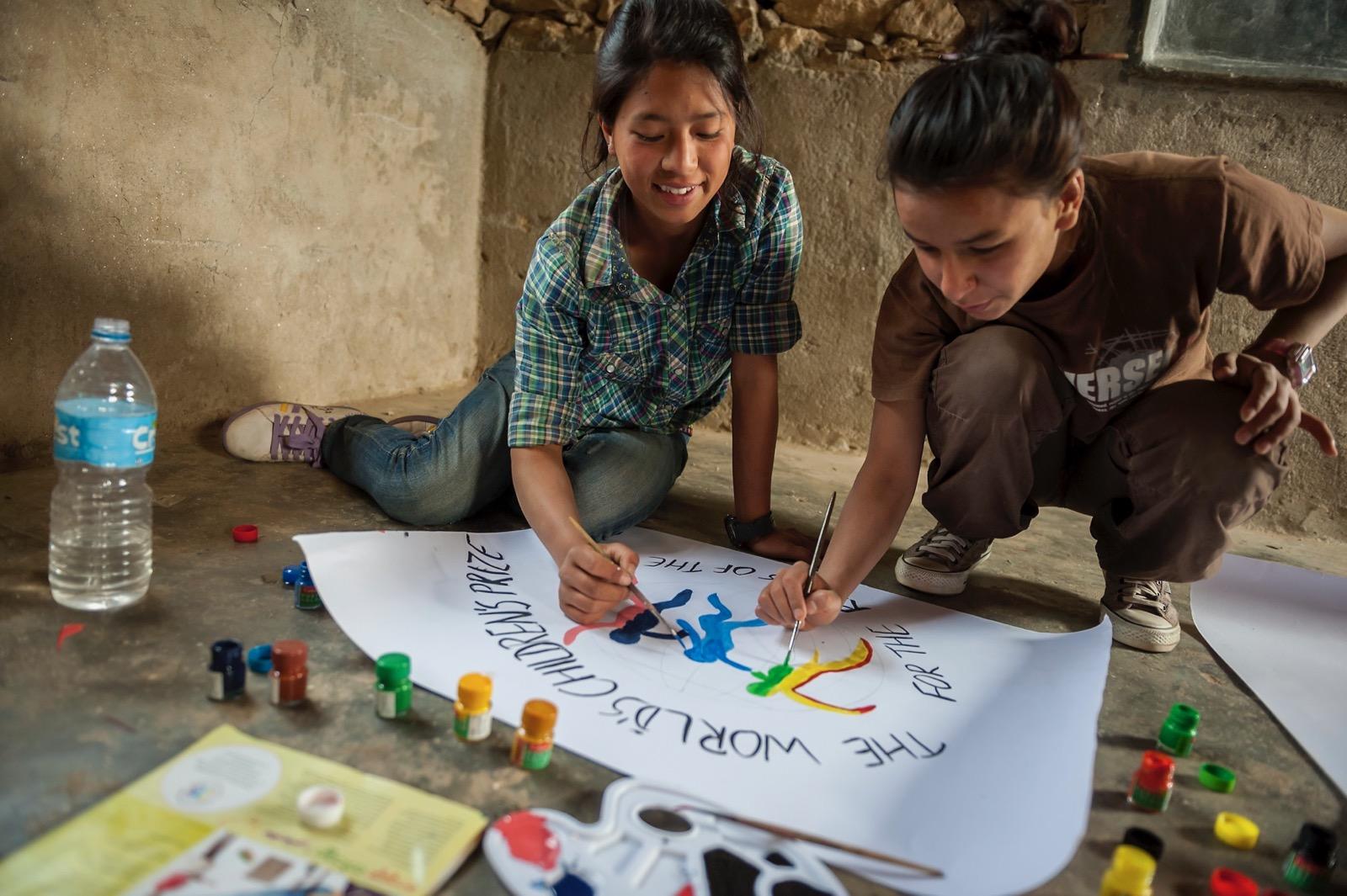 girls painting a poster