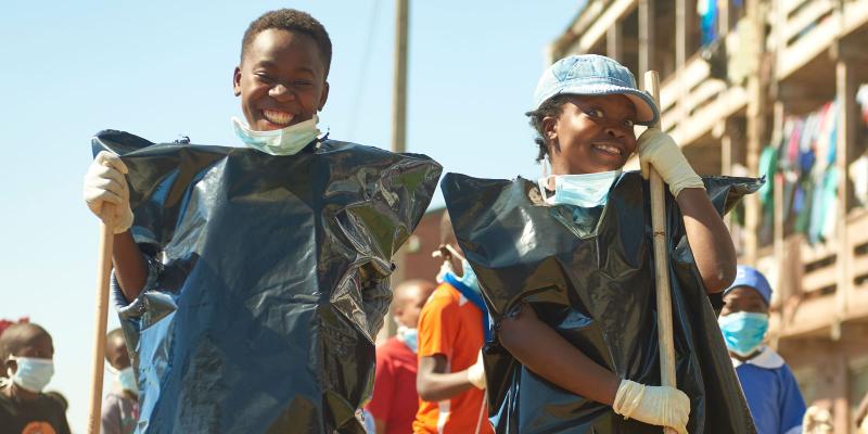 Two girls with brooms