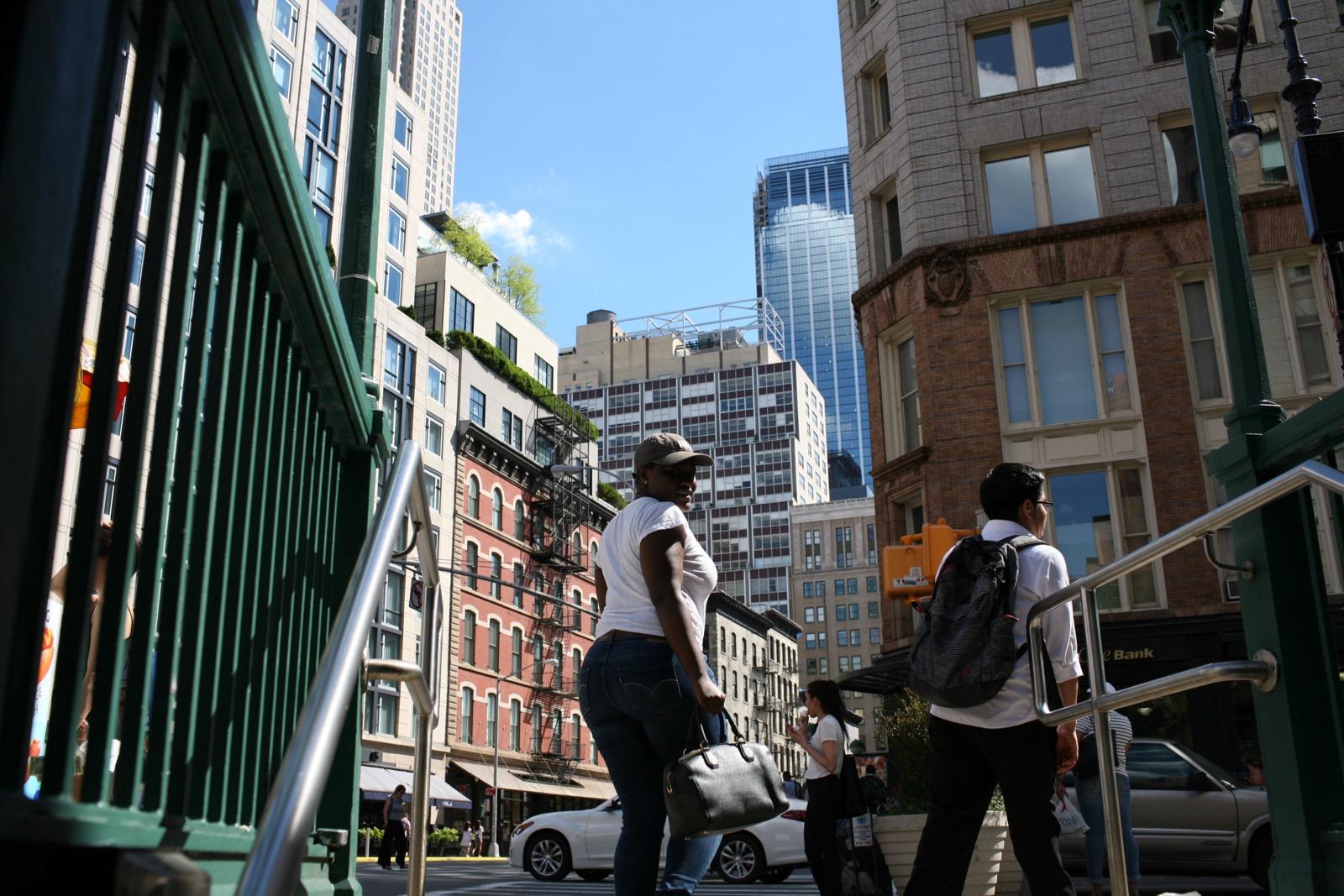 Shaquana walks up stairs from subway