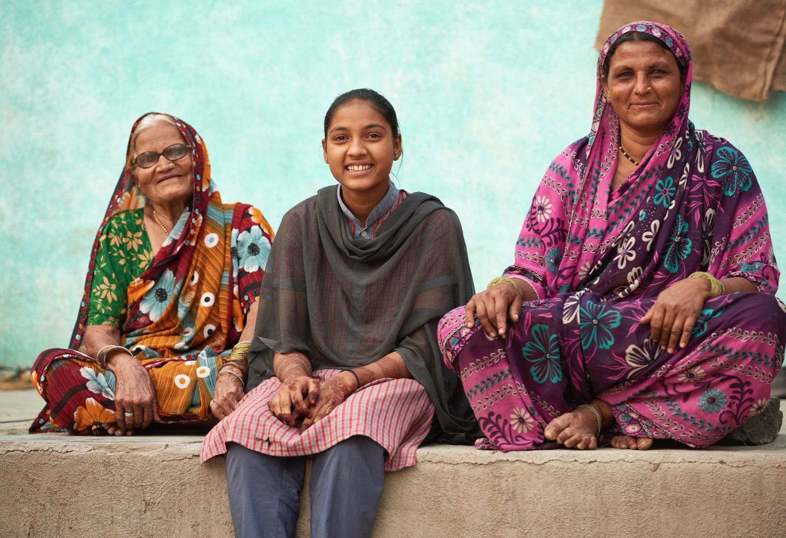 a girl and two women sitting