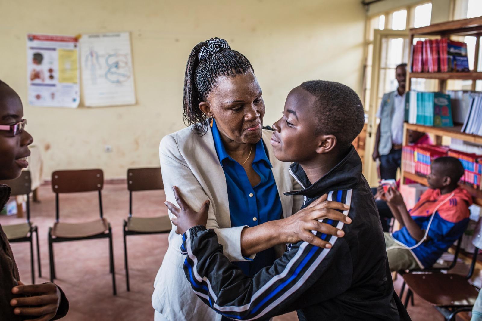A woman holding a young boy.