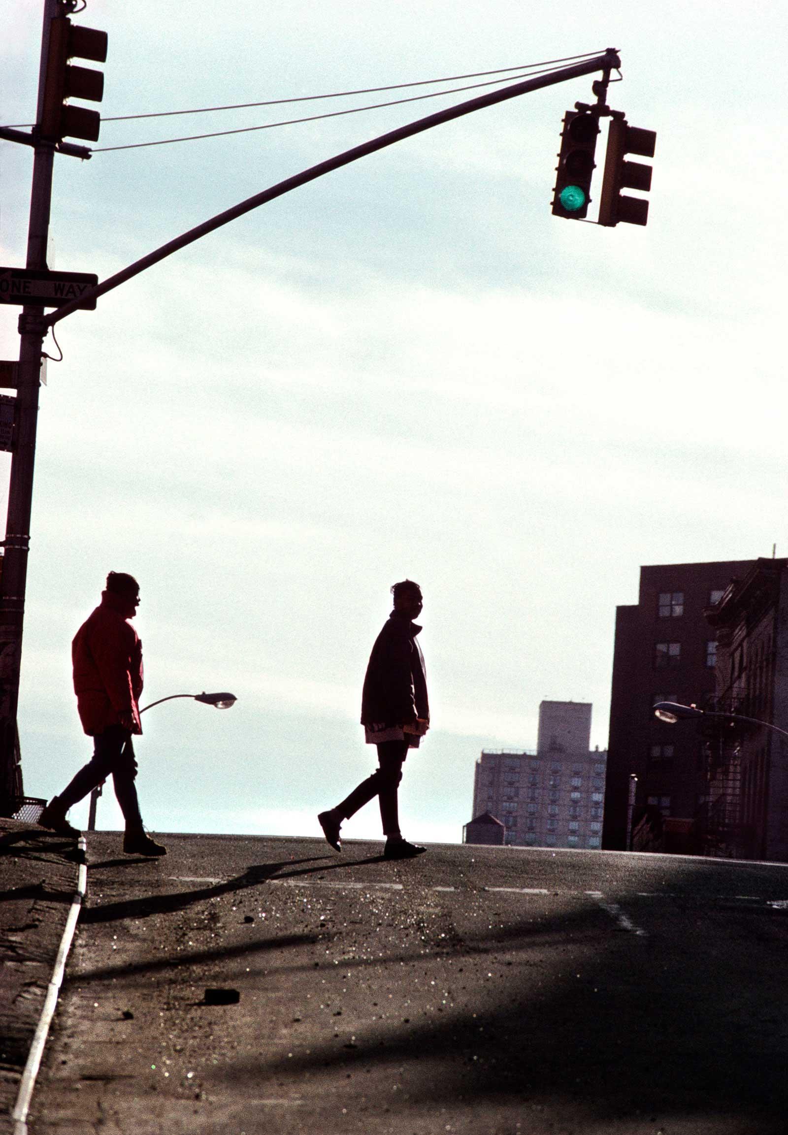 Man walking behind girl on street 