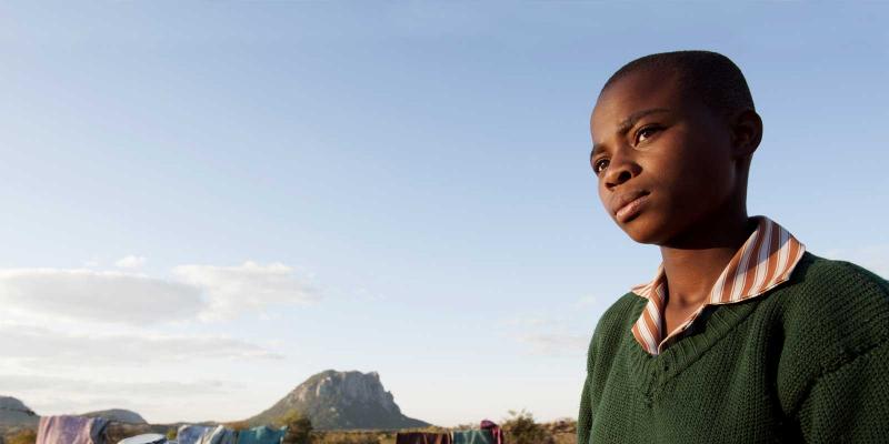 Takudza standing outside looking serious