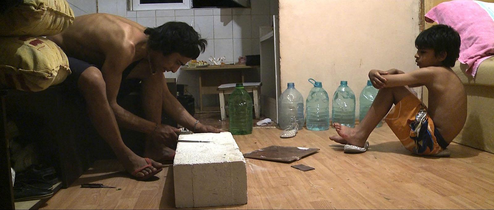 Totos uncle makes a stove.