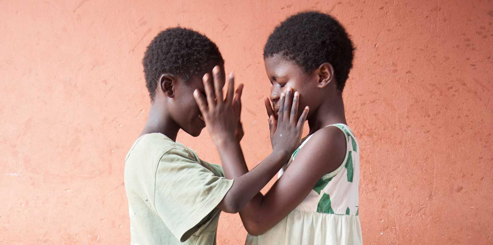 Adelia touching a friends face