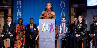 Girls giving a speech on stage.
