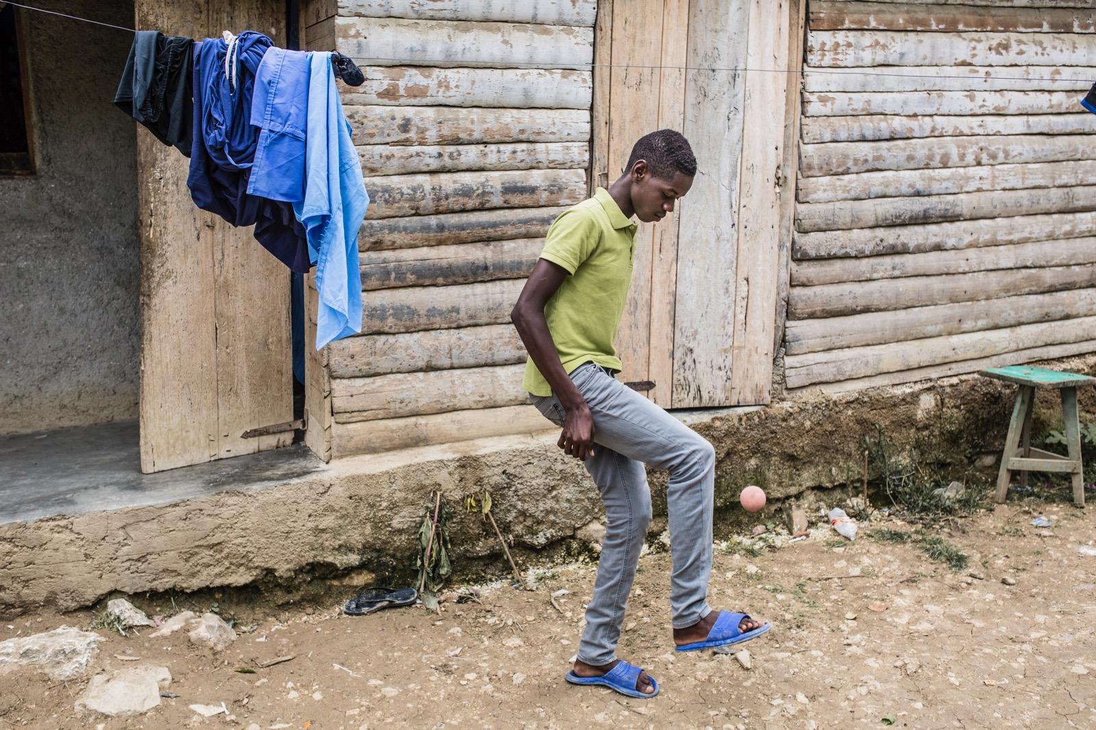 A boy playing with a ball.